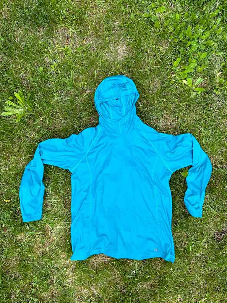 The Outdoor Research Echo Hoodie lying flat on grass