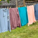 Seven hiking sun hoodies hang on a clothesline - my picks for the best sun hoodies for hiking