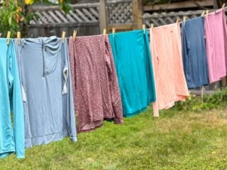 Seven hiking sun hoodies hang on a clothesline - my picks for the best sun hoodies for hiking
