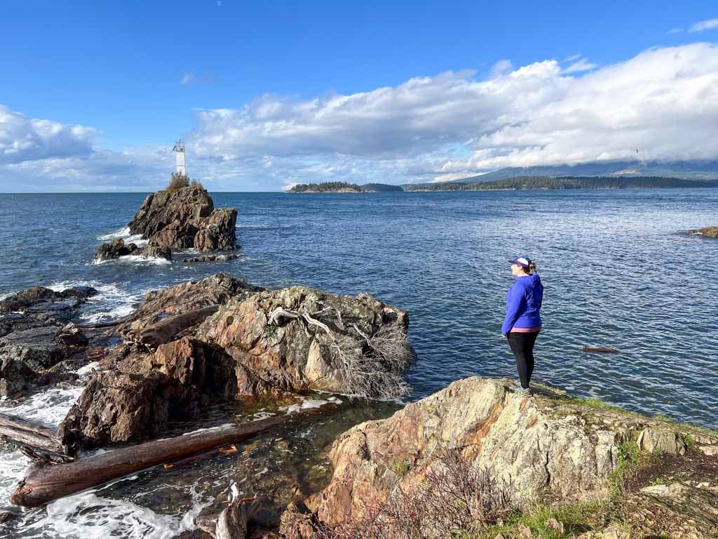 A woman stands on a rock at Cape Roger Curtis.