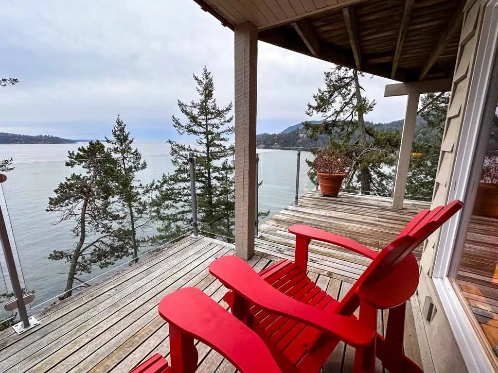 Red chairs on a cliffside patio on Bowen Island.