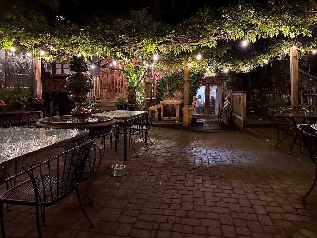 The patio at Tuscany Restaurant on Bowen Island draped with grape vines and fairy lights