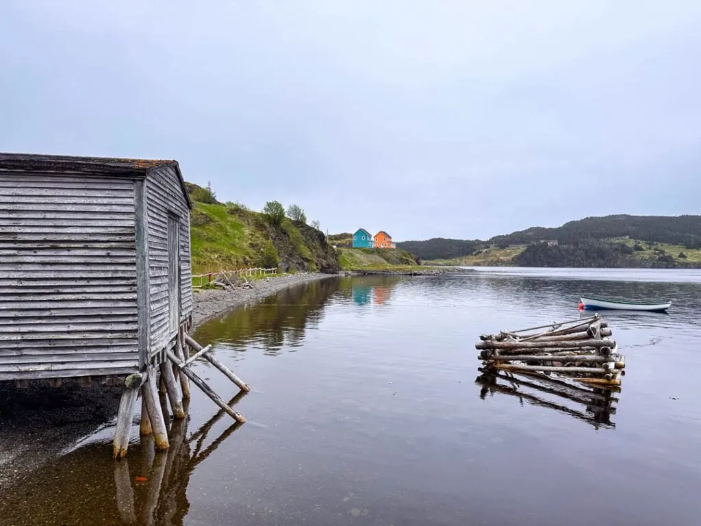 An old grey fishing hut on stilts in the ocean in Newfoundland