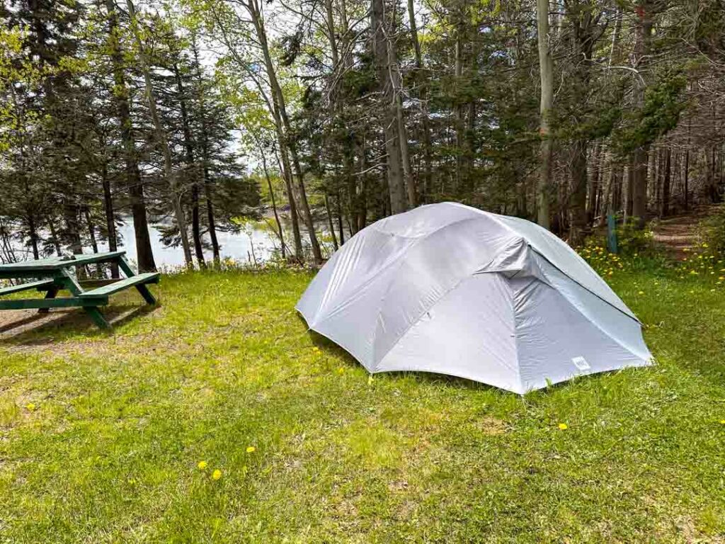 A tent at Dildo Run Provincial Park. You can see the ocean through the trees