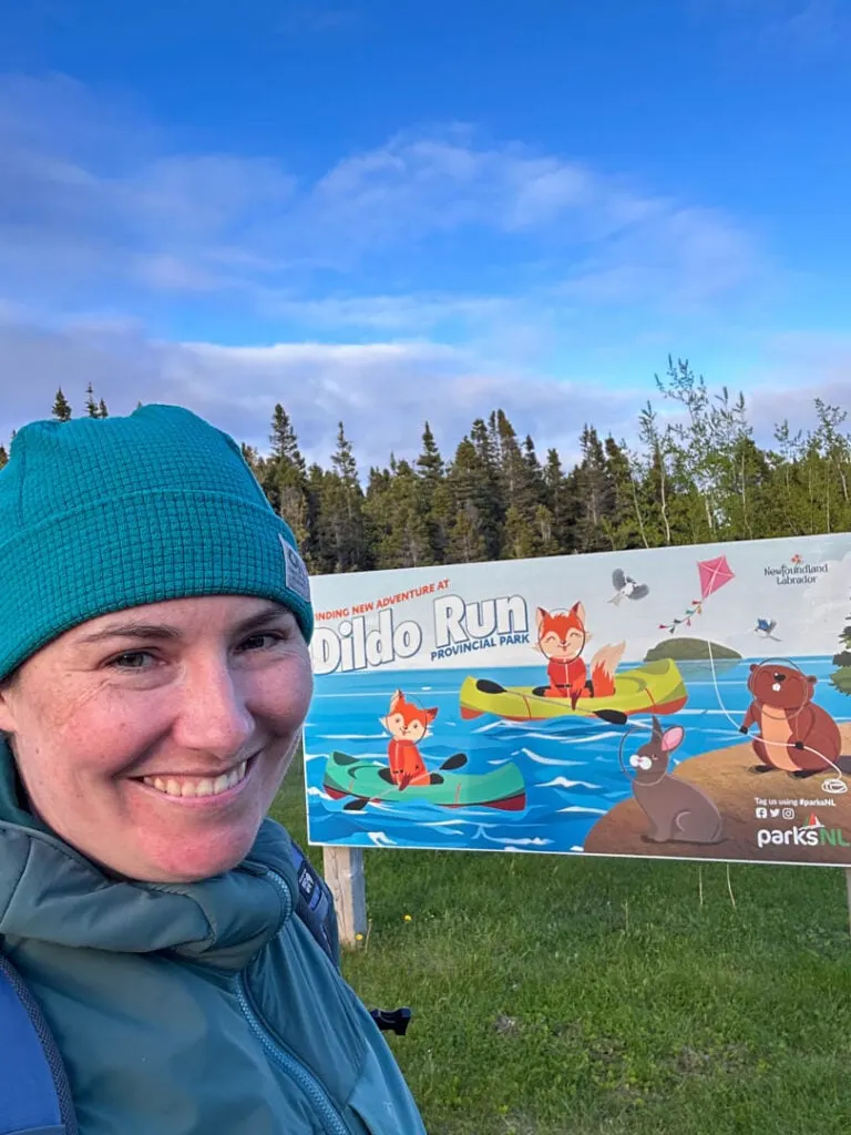 A woman takes a selfie in front of the sign at Dildo Run Provincial Park in Newfoundland