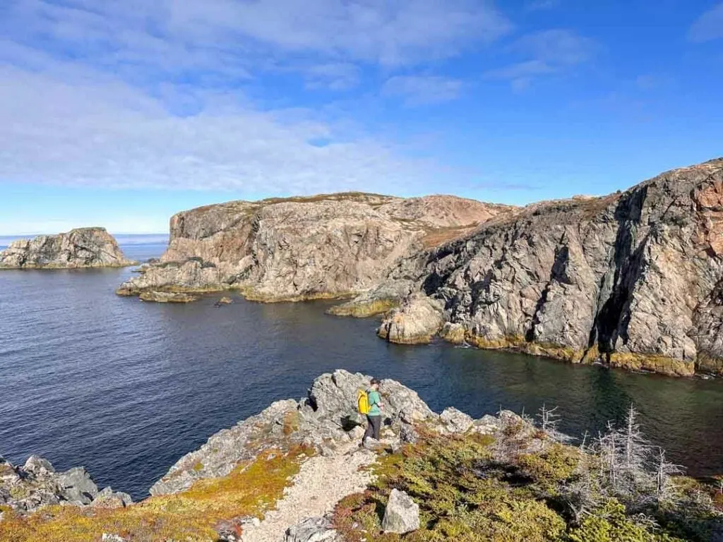 A man hikes at French Head on the Rockcut Trails