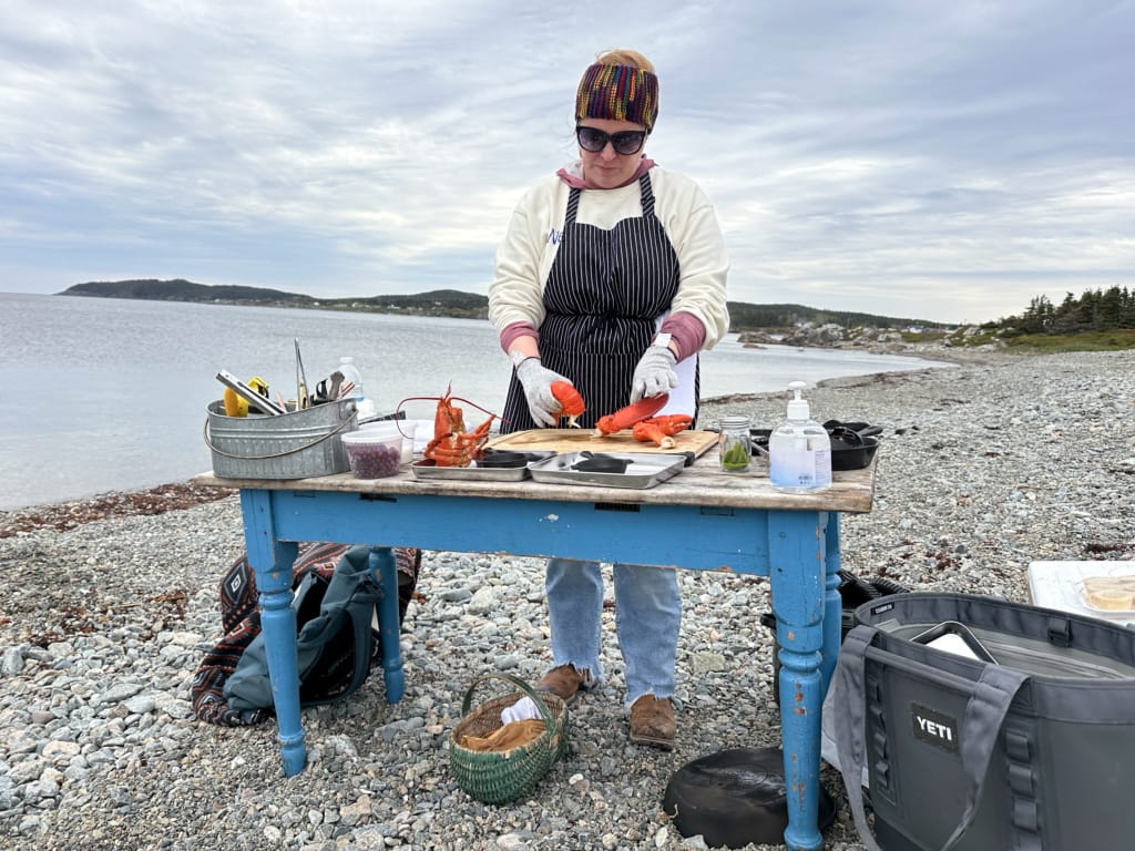 Chef Crystal from Wild Island Kitchen preparing lobster on the beach