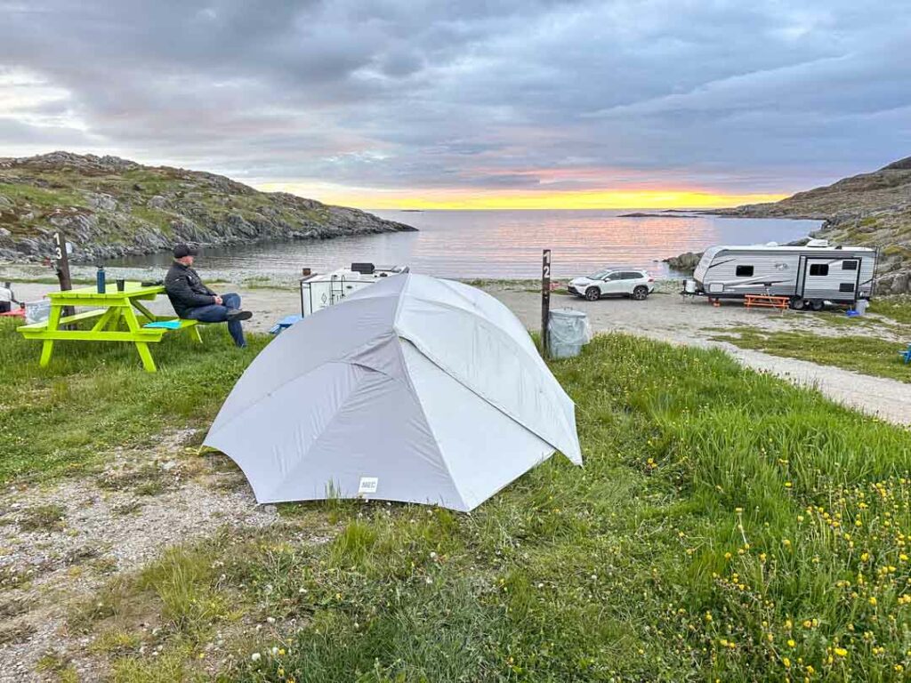 A tent in in front of the ocean at sunset at Brimstone Head RV Park on Fogo Island. 