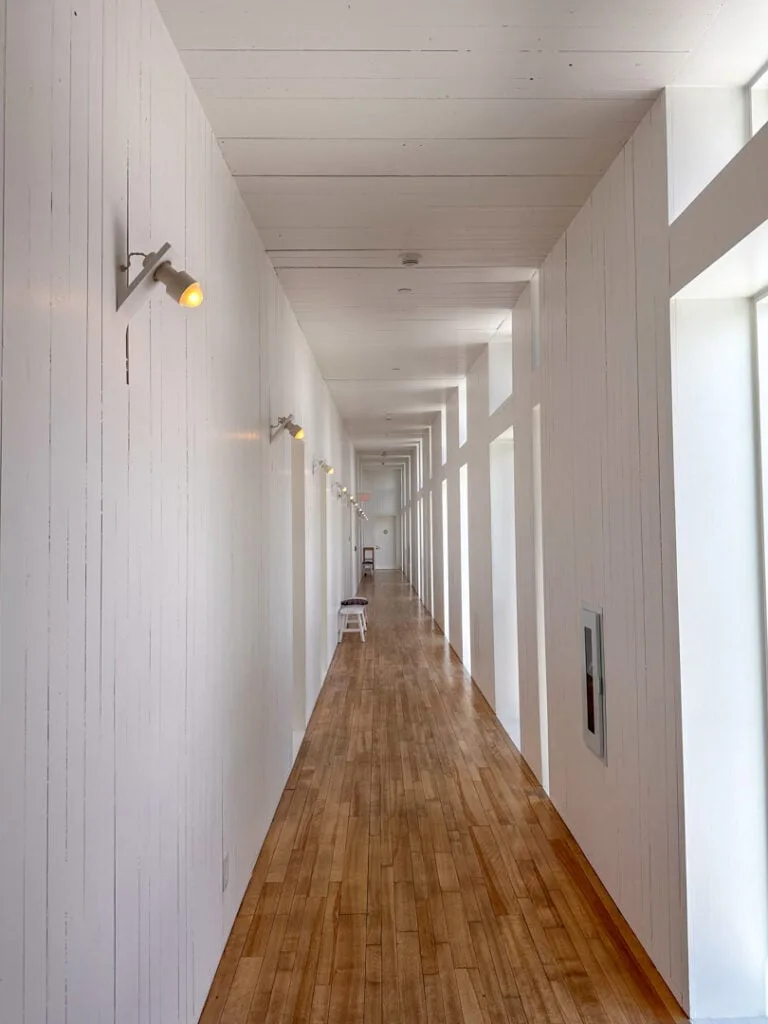 A white ship-lap hallway at the Fogo Island Inn