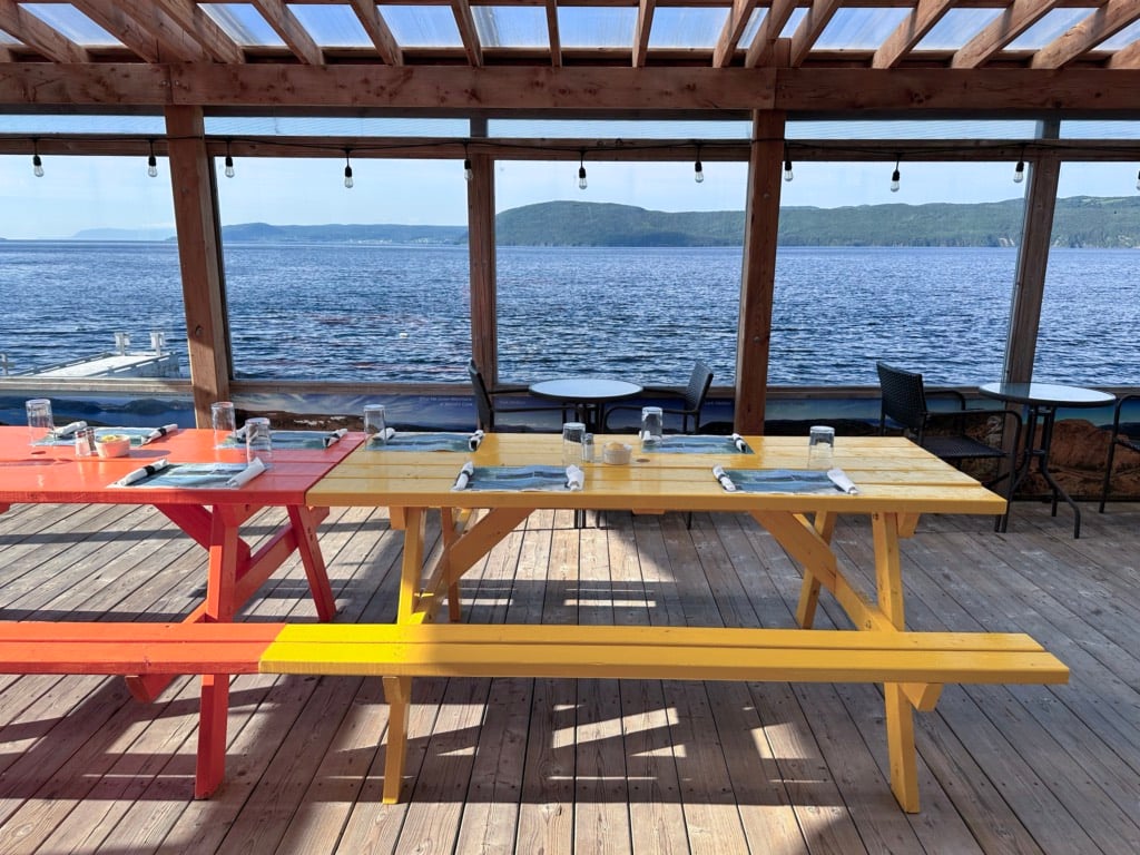 Picnic tables on the waterfront patio at the Saltbox in Benoit's Cove, Newfoundland