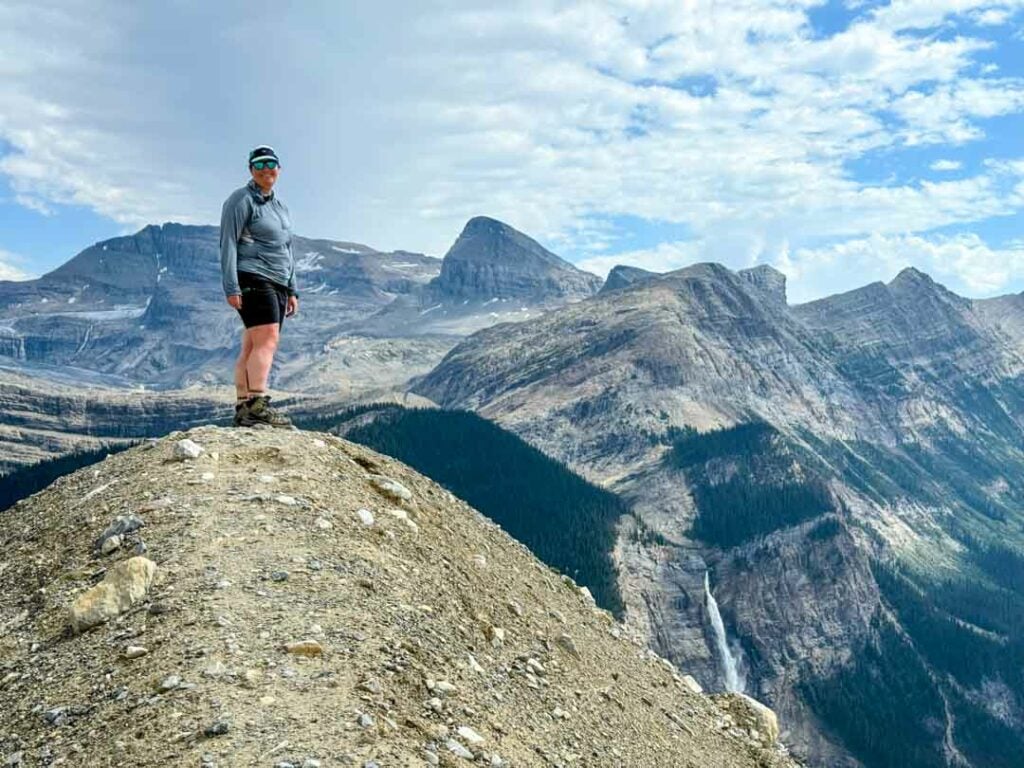 A hiker poses for a photo at a viewpoint on the Iceline Trail