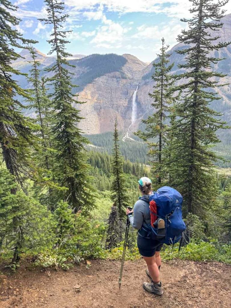 A hiker admires the view of Takakkaw Falls from the lower slopes of the Iceline Trail