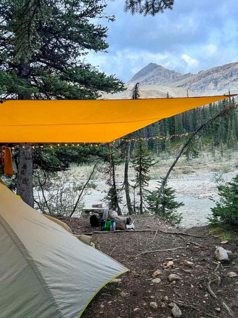 A tent under a tarp at a backcountry campground in Yoho National Park