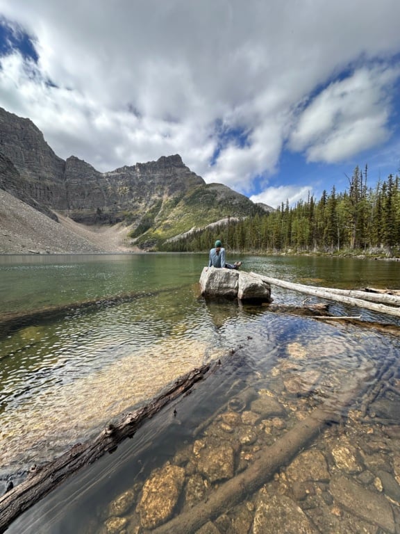 A man sits on a rock at Pharaoh Lake