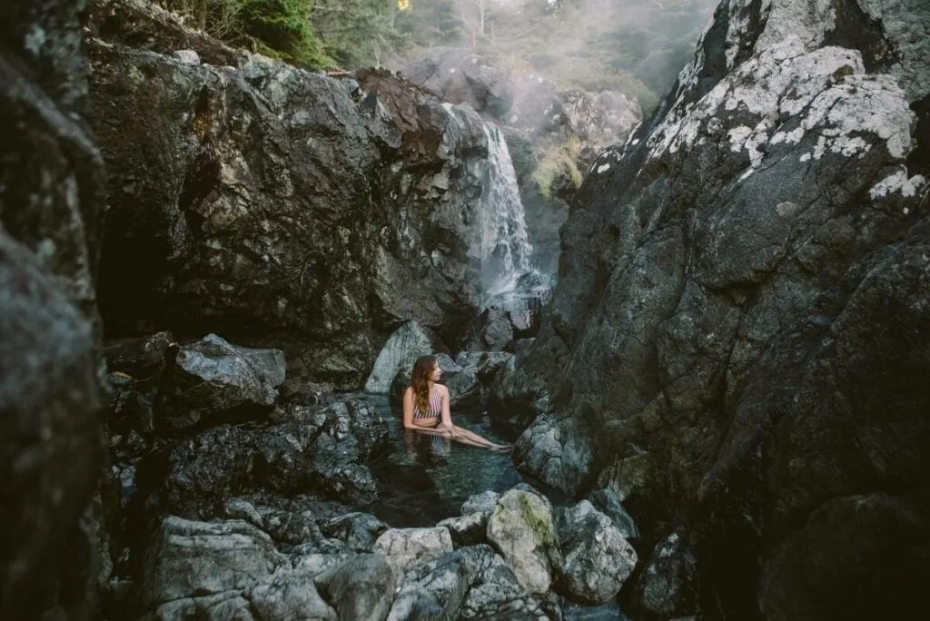 A woman sits in the natural hot springs at Hot Springs Cove near Tofino