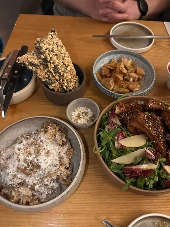 An array of bowls filled with Korean food on a table at Jeju restaurant in Tofino