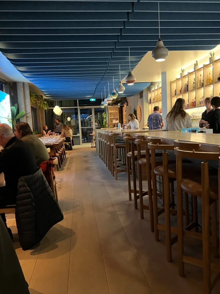 The long, modern bar and rows of tables at Ombre restaurant in Tofino