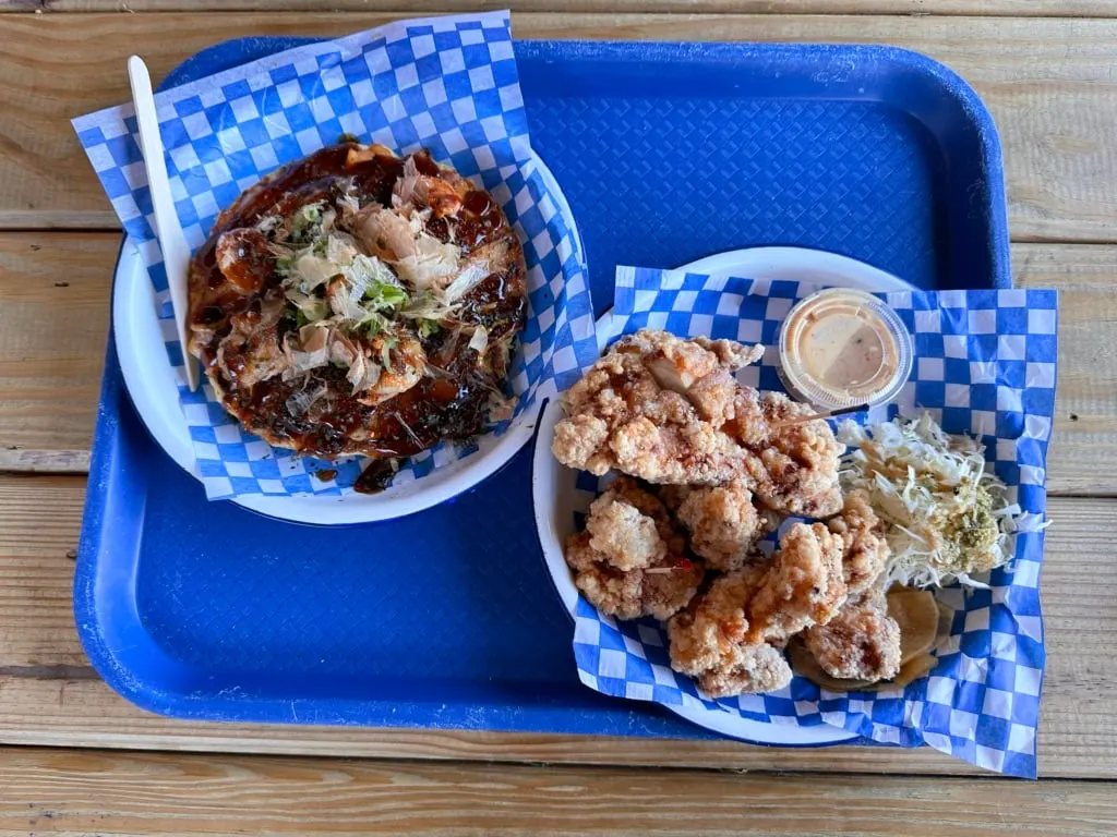 A blue tray with two dishes of food from Toki Doki