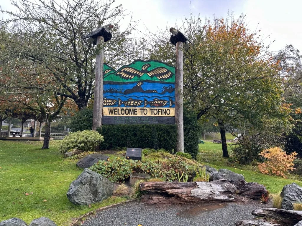 A welcome to Tofino sign with Indigenous art on it