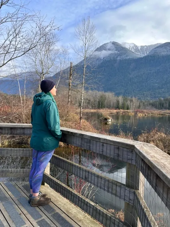 A woman wearing a green rain jacket at the Cheam Lake Wetlands