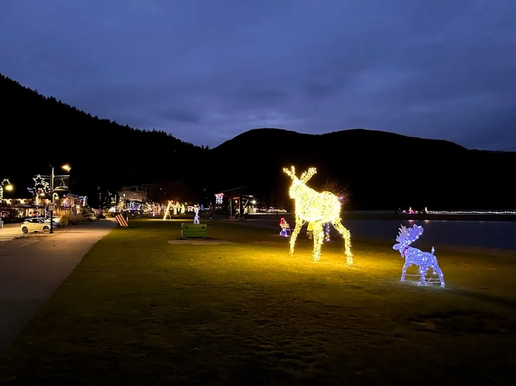 A light up moose in the foreground with lots of holiday lights in the background along the Esplanade in Harrison