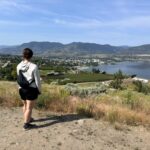 A woman enjoys the view of Penticton from Munson Mountain - one of the best things to to in Penticton in the summer