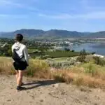 A woman enjoys the view of Penticton from Munson Mountain - one of the best things to to in Penticton in the summer