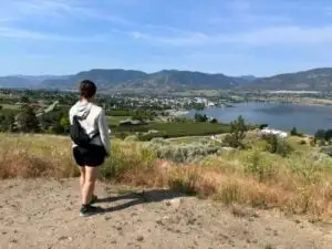 A woman enjoys the view of Penticton from Munson Mountain - one of the best things to to in Penticton in the summer