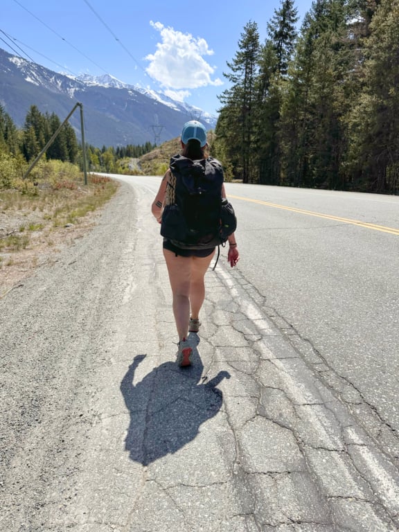 A hiker walking along Highway 99
