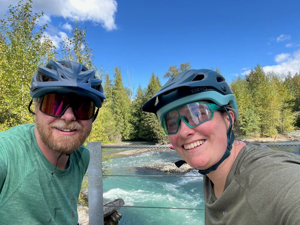 Two cyclists take a selfie on a suspension bridge along the Sea to Sky Trail