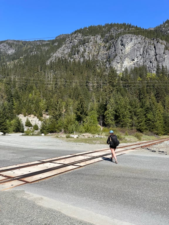 A hiker crosses Highway 99