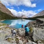 A group of hikers at Myotosis Lake on the Skoki Loop in Banff National Park