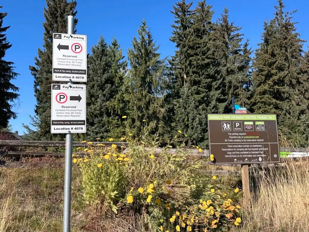 Signs at the designated overnight parking area in Whistler for Russet Lake 
