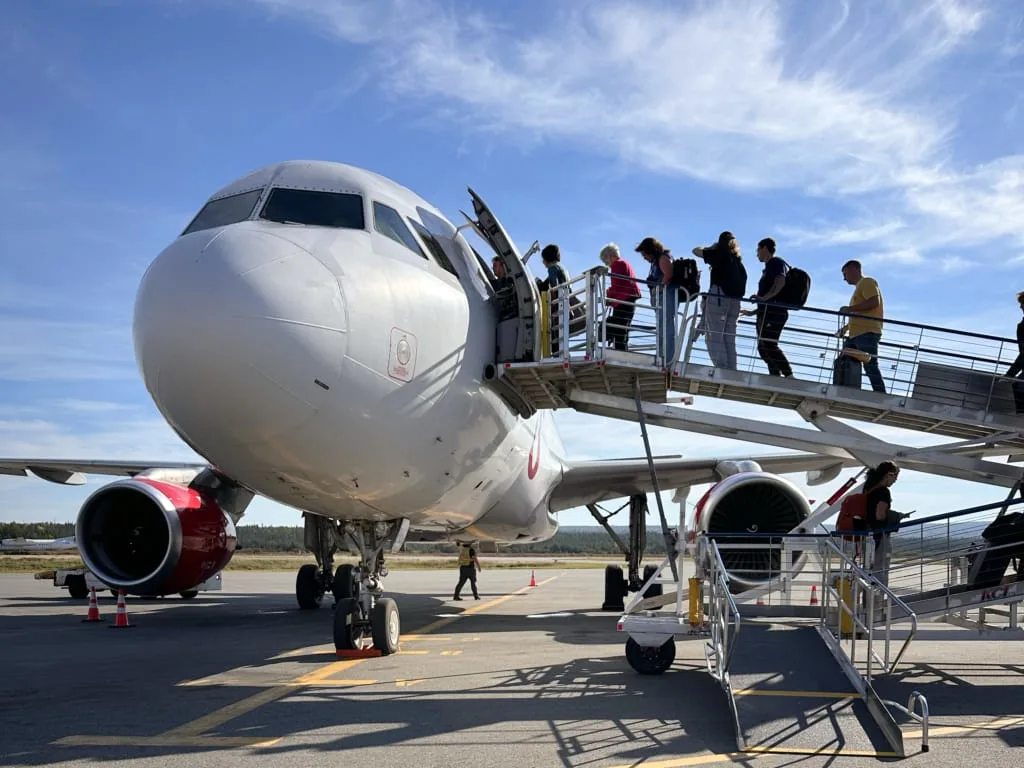 Passengers board a plane via a ramp at the Deer Lake Airport