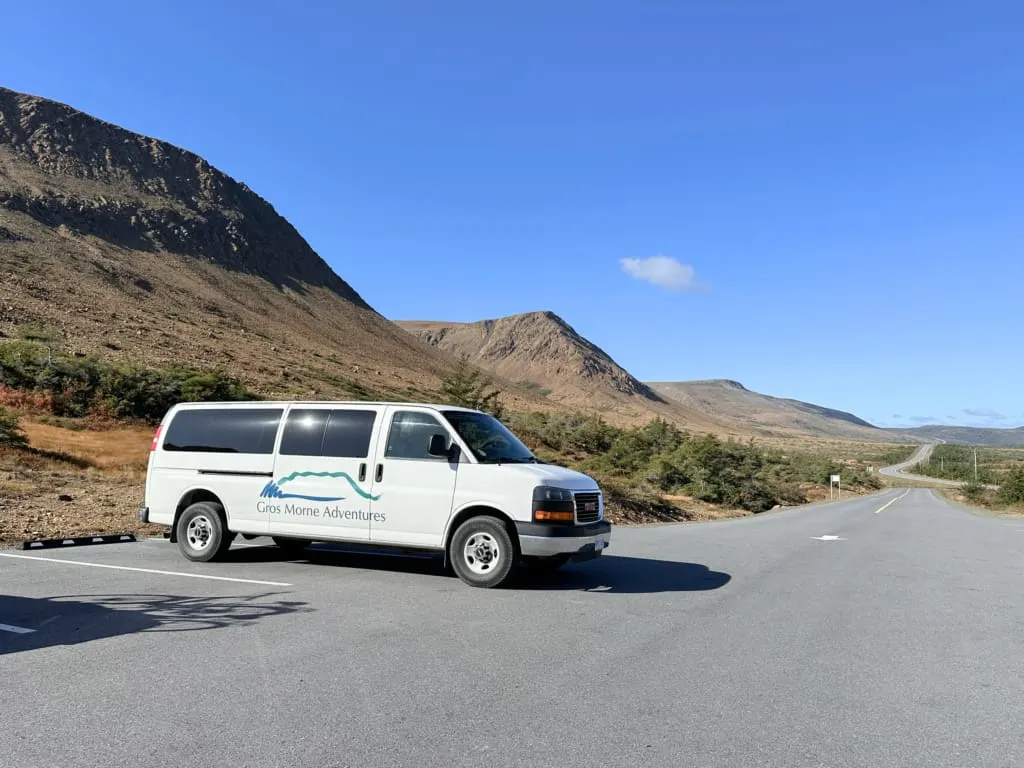Gros Morne Adventures tour van parked at Tablelands in fall in Gros Morne National Park