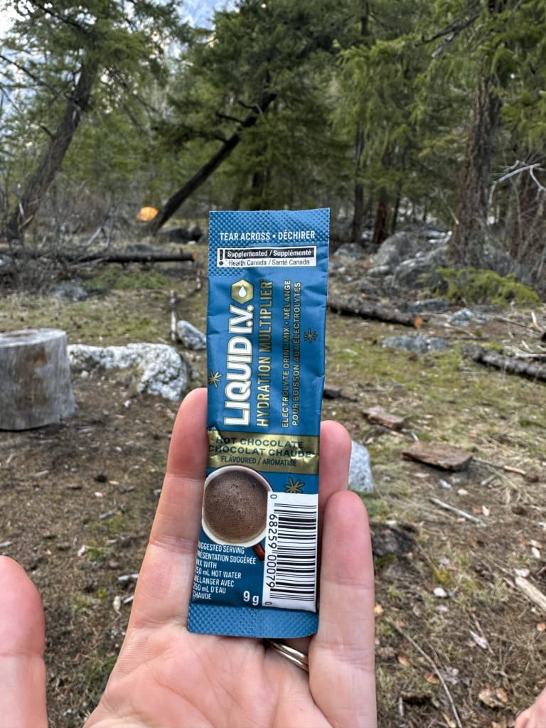 A person hold a packet of Liquid I.V. Hot Chocolate Electrolyte Drink Mix