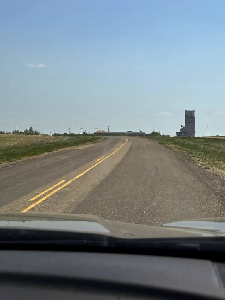 View through the windshield of a small Saskatchewan highway