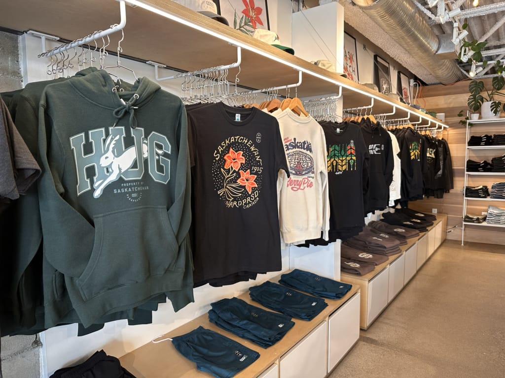 Screen printed shirts with local designs on display at Hardpressed Print Studio in Saskatoon