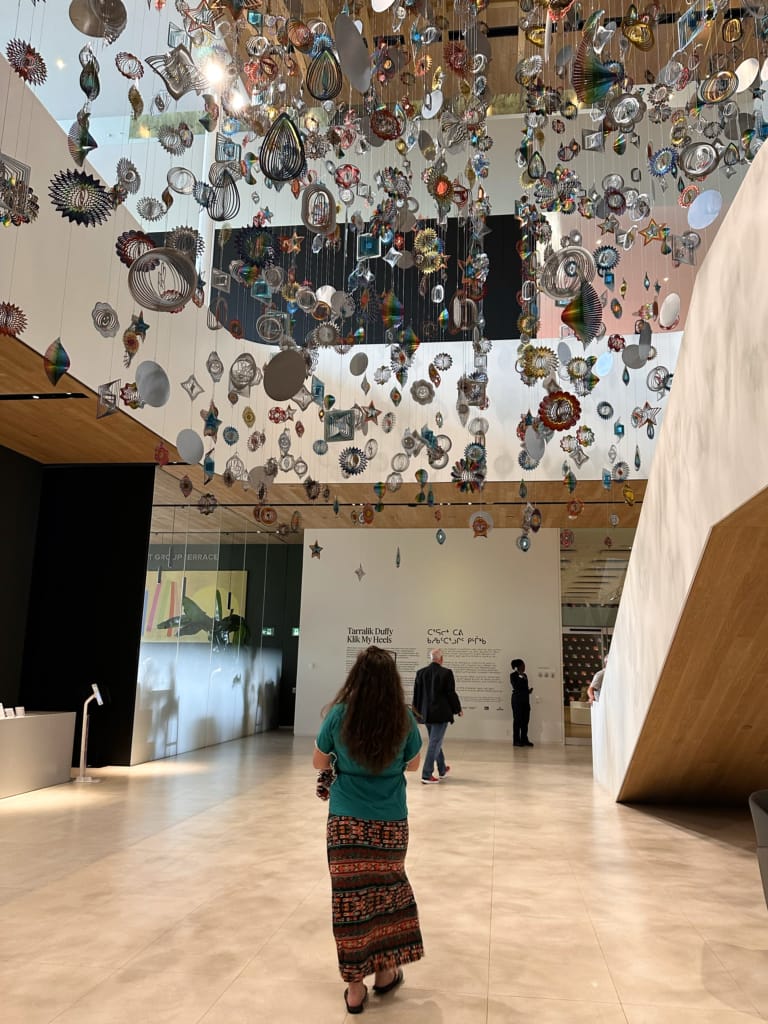 An art installation hangs from the ceiling in the entrance to Remai Modern art musem