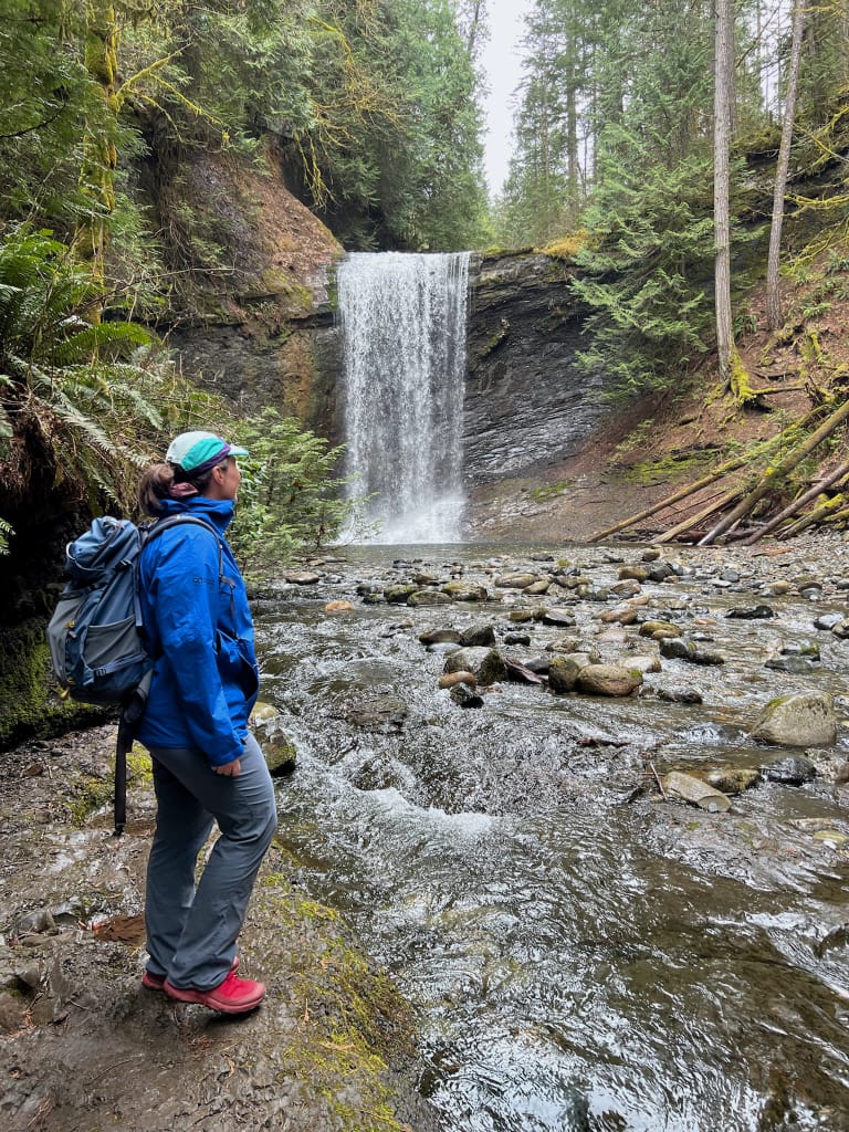 A woman poses at Ammonite Falls