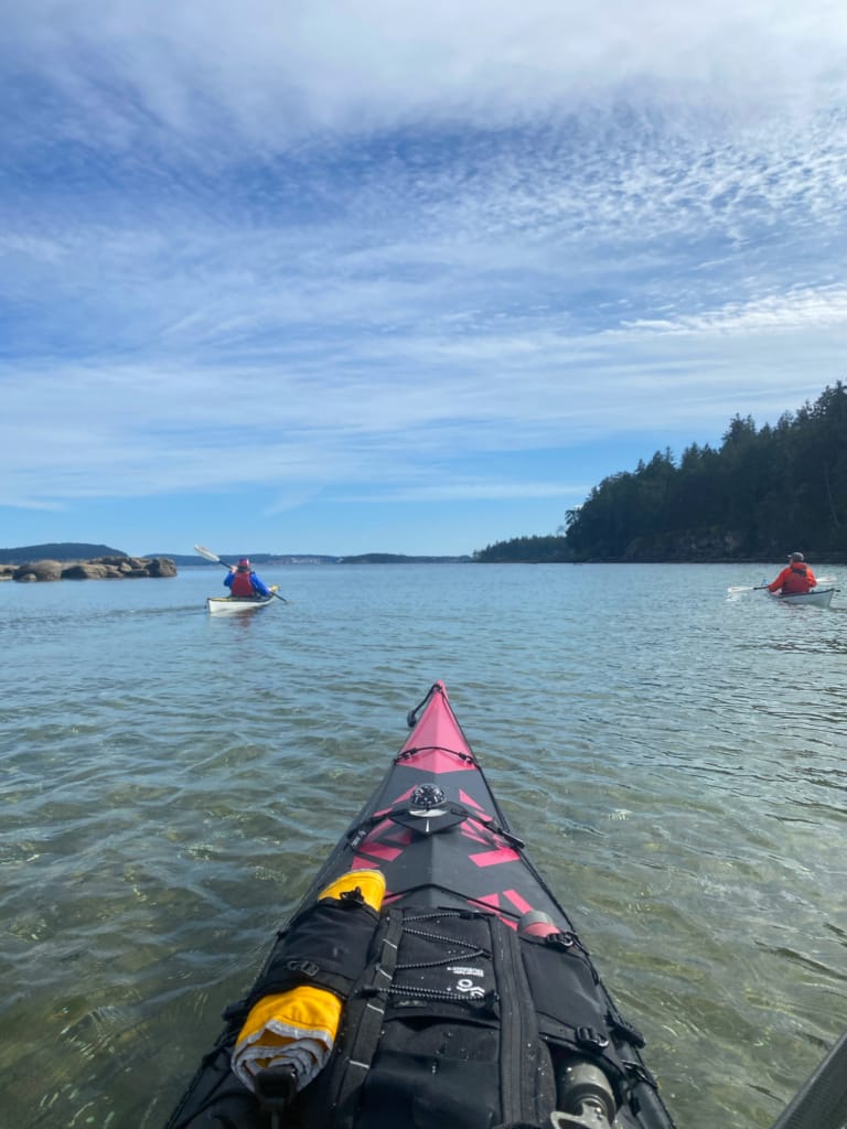 A kayaker takes a photo of two other kayakers near Saysutshun in Nanaimo
