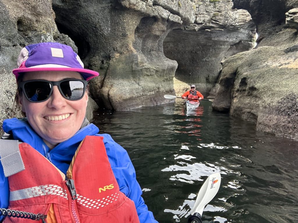A woman takes a selfie while kayaking through a sea cave in Nanaimo. 