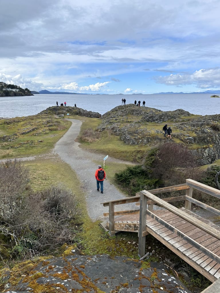 A man walks on a path in Neck Point Park