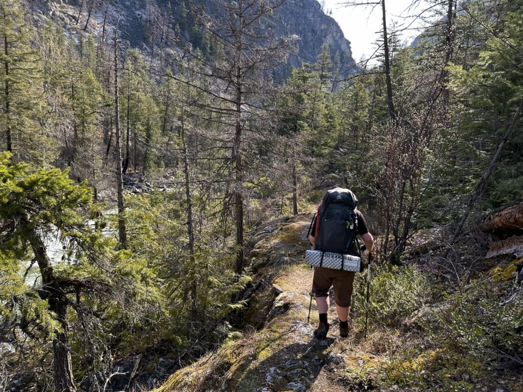 A hiker on the bluffs on Devil's Staircase Hill in the Stein Valley