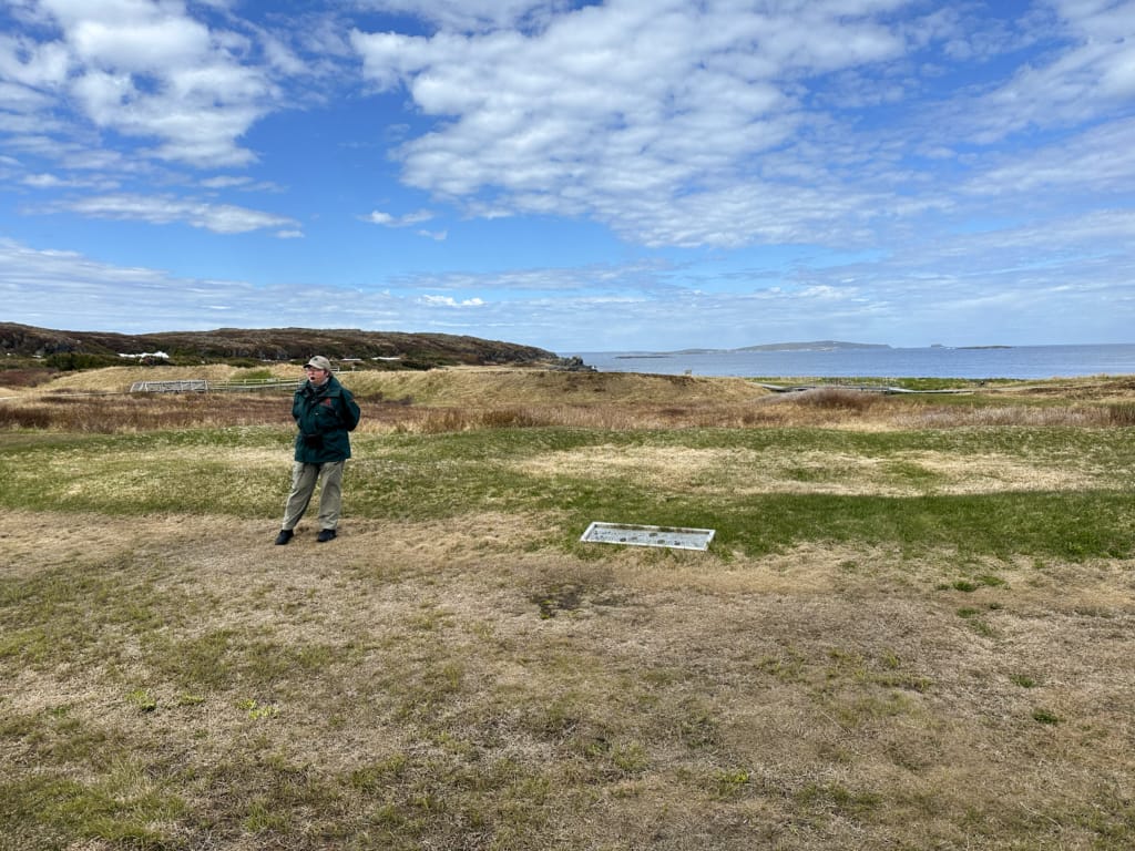 A Parks Canada guide leading a tour at L'Anse aux Meadows