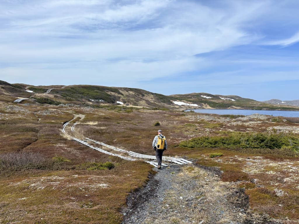 A man hikes on Quirpon Island