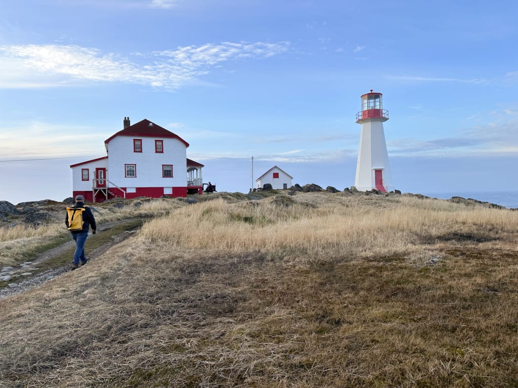 A hiker arrives at the Quirpon Lighthouse Inn