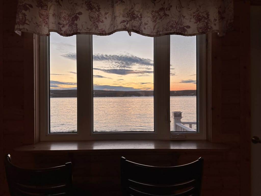 Sunset seen through the window of one of the Burnt Cape Cabins in Raleigh, Newfoundland