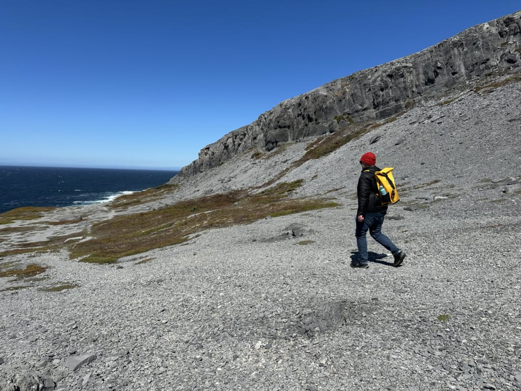 A man hikes through gravel in Burnt Cape Ecological Reserve, on the Great Northern Peninsula in Newfoundland