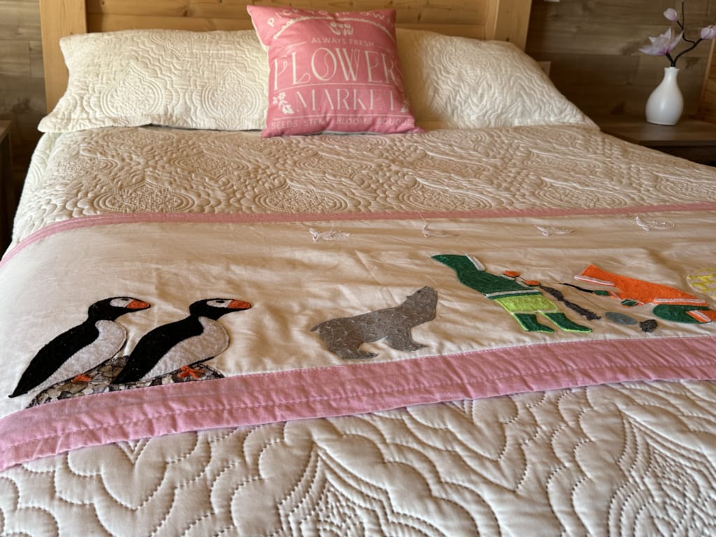 Hand embroidered bedspread at Raleigh Rooms in Raleigh, NL